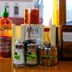 Condiments on a table inside the New Spicy Village in Chinatown